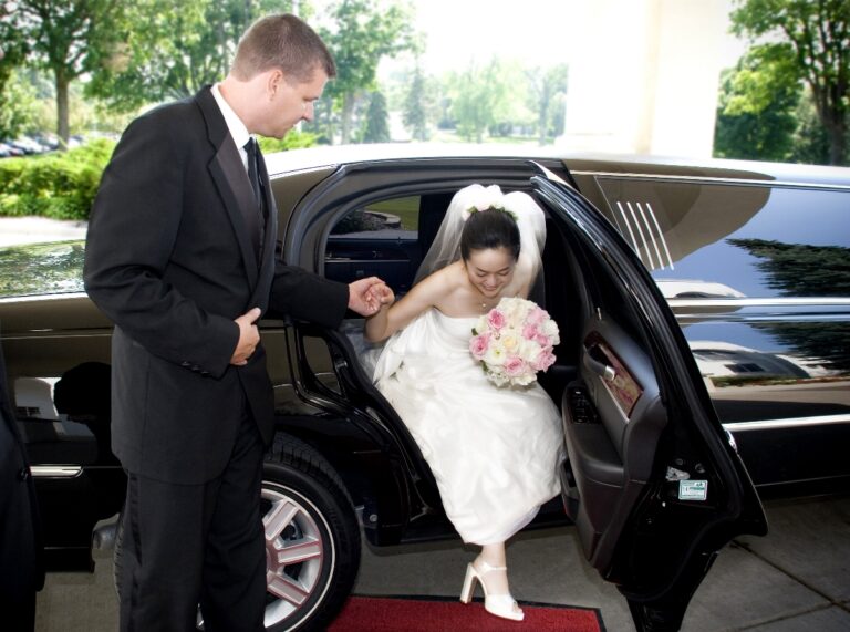 Bride being helped out of Stretch Limo